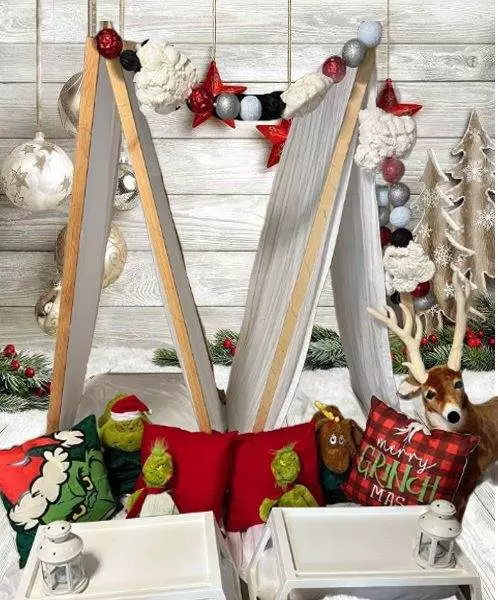 Christmas themed teepee tents with Grinch and reindeer pillows.